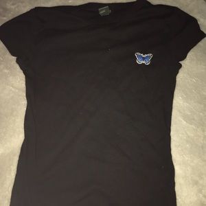 Tight shirt with blue butterfly on it